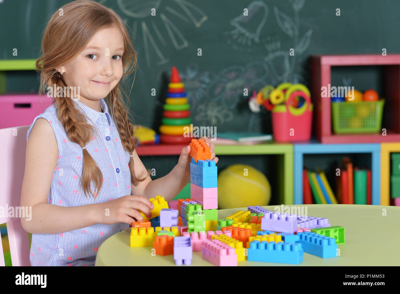 little girl with colorful plastic blocks Stock Photo - Alamy