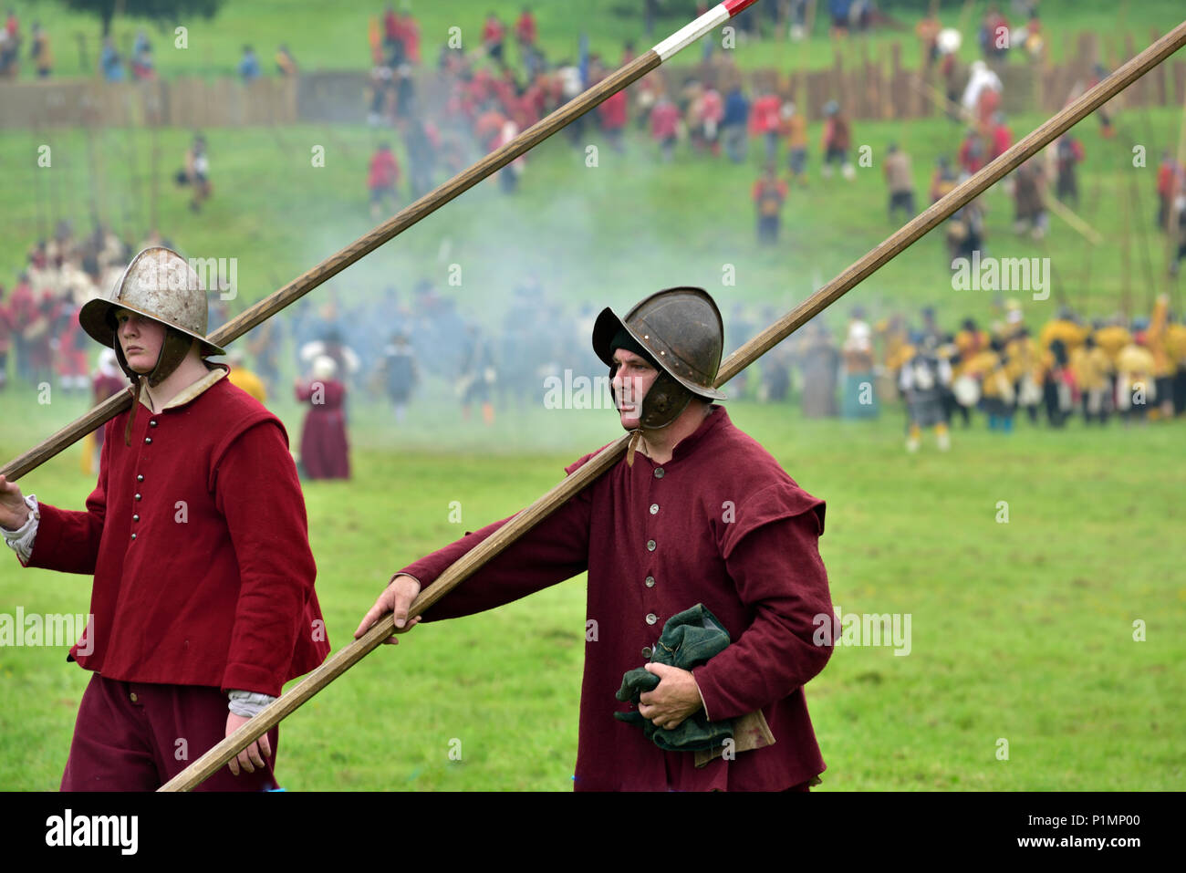 Two pikemen foot soldiers carrying their pikes in 17th century custom in English Civil War reenactment Stock Photo