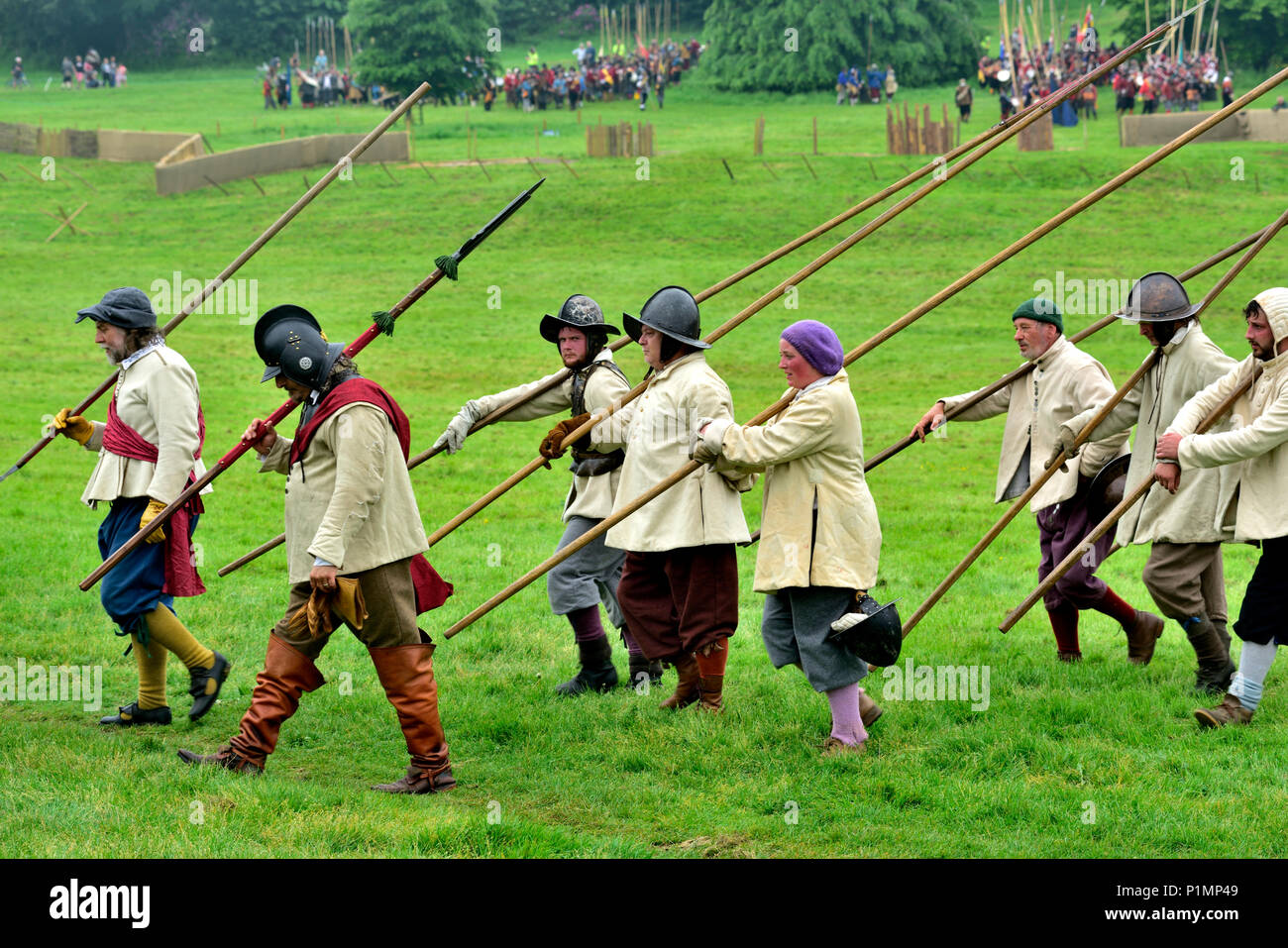 Pikemen foot soldiers marching carrying their pikes in 17th century buff coat costumes in English Civil War reenactment Stock Photo