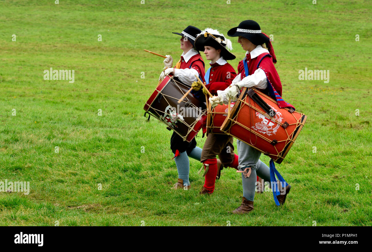 Three marching drummers in 17th century costumes during English Civil war re-enactment, years 1641 to 1652, UK Stock Photo