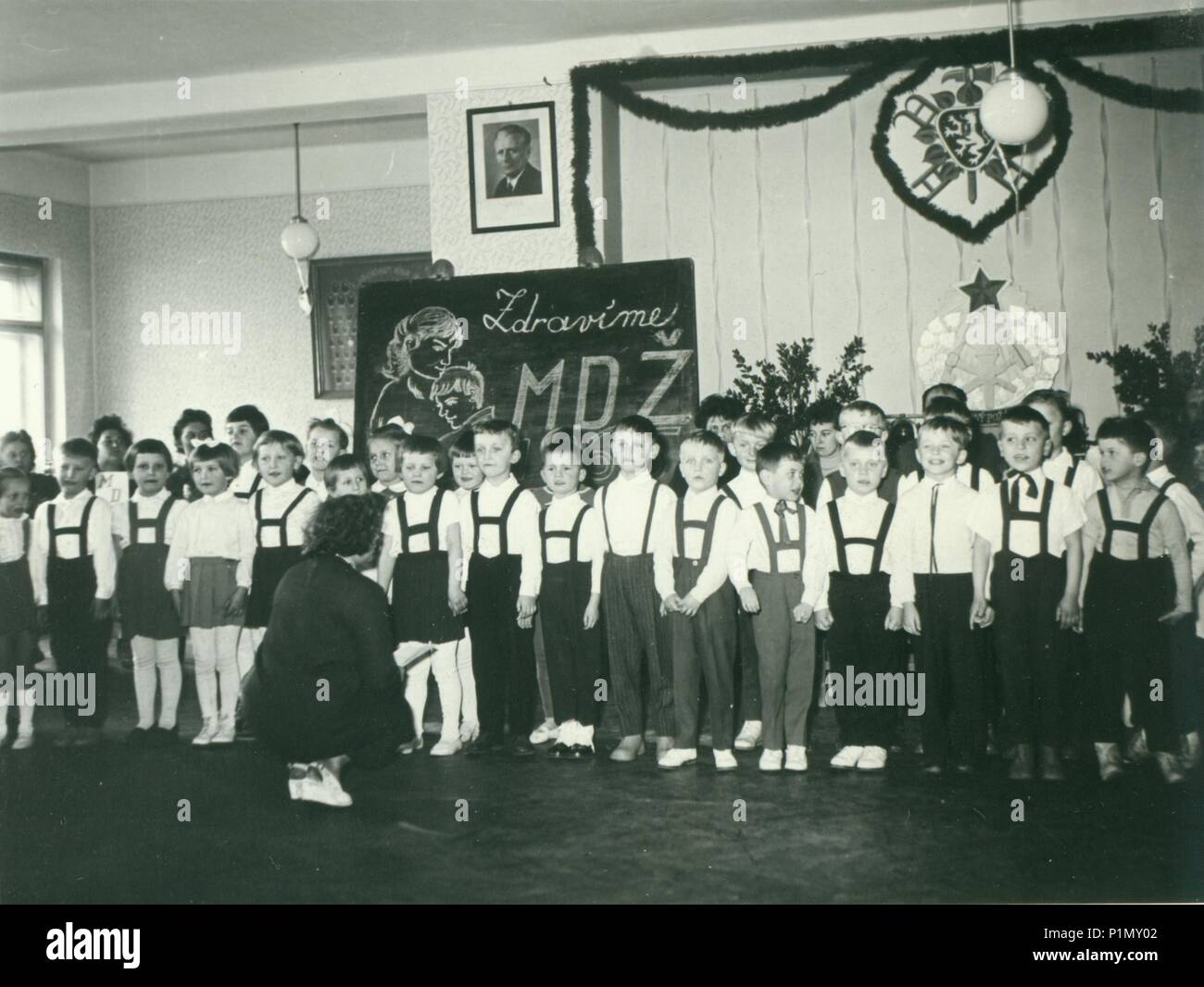 THE CZECHOSLOVAK SOCIALIST REPUBLIC - CIRCA 1960s: Retro photo shows pupils in the classroom. They celebrate  International Women's Day (IWD). Vintage black & white photography. Stock Photo