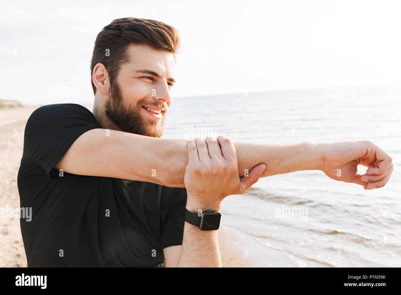 Young man stretching arm sunrise hi-res stock photography and images ...