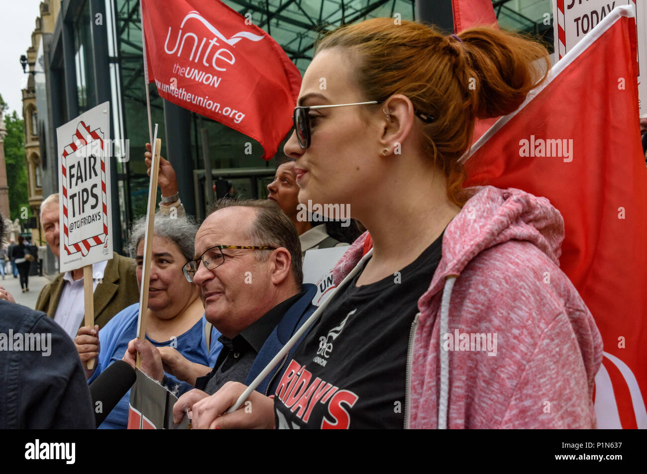 London, UK. 12th June 2018. Strikers from TGI Fridays, others from the Unite  Restaurant, Catering and Bar Workers Branch and Unite Community came to the Department of Business, Energy, Innovation and Skills with a man dressed as a giant burger to deliver a letter to business secretary Greg Clark calling on him to put an end to employers taking a part of the credit card tips that customers leave. Two years ago his predecessor Sajid Javid promised to tackle the problem but nothing has been done. Credit: Peter Marshall/Alamy Live News Stock Photo