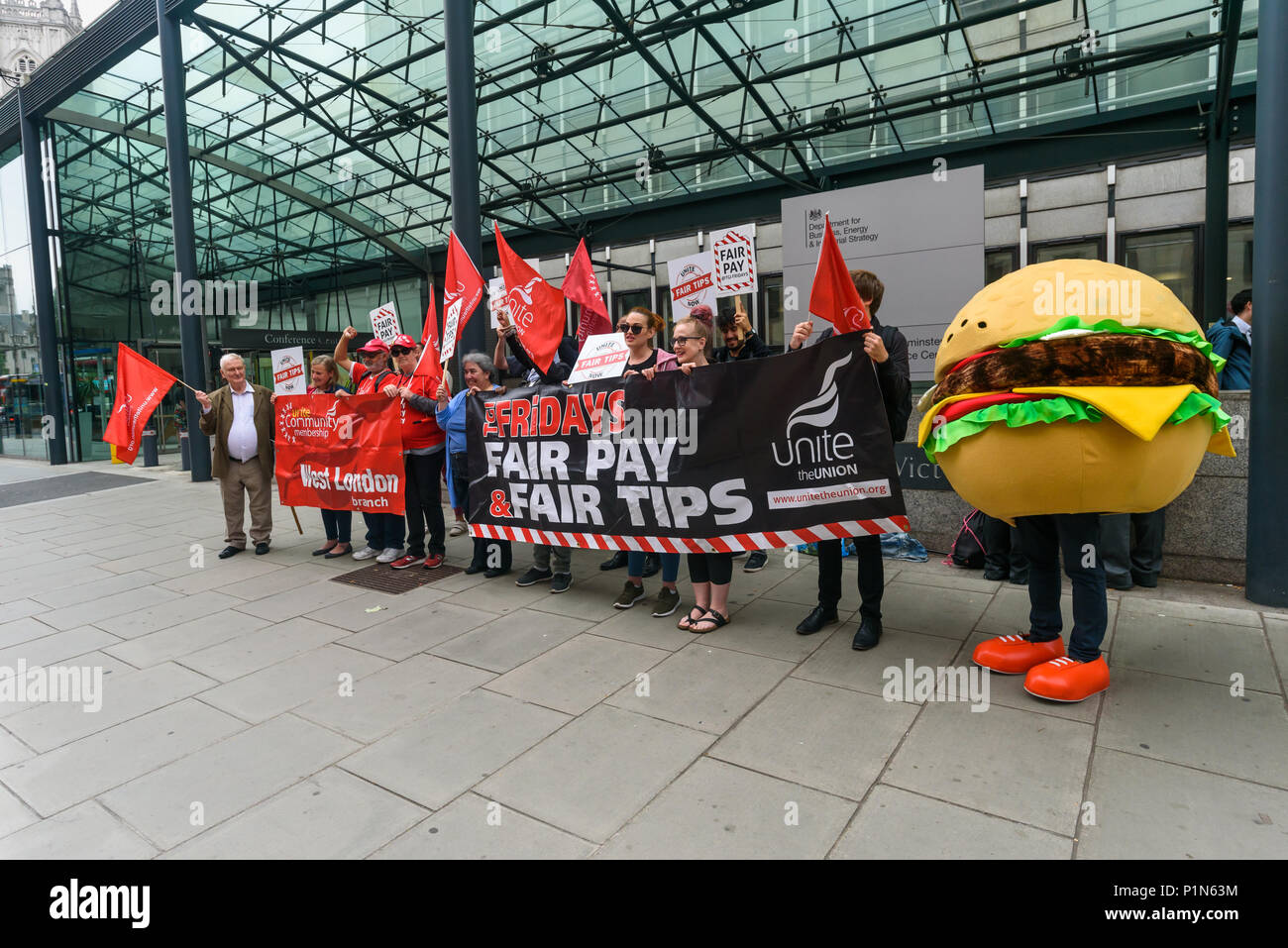 London, UK. 12th June 2018. Strikers from TGI Fridays, others from the Unite  Restaurant, Catering and Bar Workers Branch and Unite Community came to the Department of Business, Energy, Innovation and Skills with a man dressed as a giant burger to deliver a letter to business secretary Greg Clark calling on him to put an end to employers taking a part of the credit card tips that customers leave. Two years ago his predecessor Sajid Javid promised to tackle the problem but nothing has been done. Credit: Peter Marshall/Alamy Live News Stock Photo