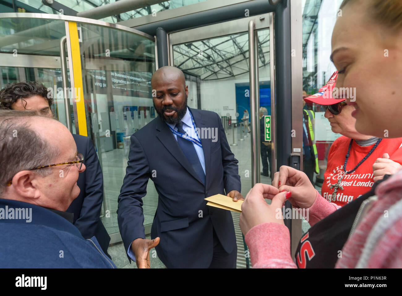 London, UK. 12th June 2018. Strikers from TGI Fridays, others from the Unite Restaurant, Catering and Bar Workers Branch and Unite Community hand in a letter  to security for  to business secretary Greg Clark at the Department of Business, Energy, Innovation and Skills calling on him to put an end to employers taking a part of the credit card tips that customers leave. Two years ago his predecessor Sajid Javid promised to tackle the problem but nothing has been done. Credit: Peter Marshall/Alamy Live News Stock Photo