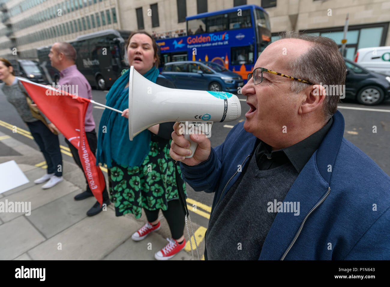 London, UK. 12th June 2018. Strikers from TGI Fridays, others from the Unite  Restaurant, Catering and Bar Workers Branch and Unite Community came to the Department of Business, Energy, Innovation and Skills with a man dressed as a giant burger to deliver a letter to business secretary Greg Clark calling on him to put an end to employers taking a part of the credit card tips that customers leave. Two years ago his predecessor Sajid Javid promised to tackle the problem but nothing has been done. Credit: Peter Marshall/Alamy Live News Stock Photo