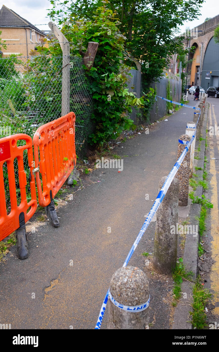 South Harrow, London, England. 12th June 2018. Police search for clues and protect the scene of the latest violent incident in Harrow, contributing to the continuous violent crime rates in London. The location is very close to recent stabbing of a 17 year old and is part of the same investigation.  The Police would only say that someone had been very badly injured. They were undertaking a finger tip search of the crime scene on Roxeth Green Avenue, South Harrow. Credit © Tim Ring/Alamy Live News Stock Photo