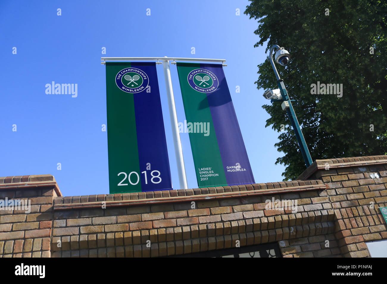 London UK. 13th June 2018.  Roll of Honour Banners  showing the 2017 Wimbledon Men's and Ladies Singles champions Roger Federer and Garbine Muguruza are displayed at the gates of the AELTC in Wimbledon with 3 weeks left until the start of the 2018 Tennis Championships Credit: amer ghazzal/Alamy Live News Stock Photo