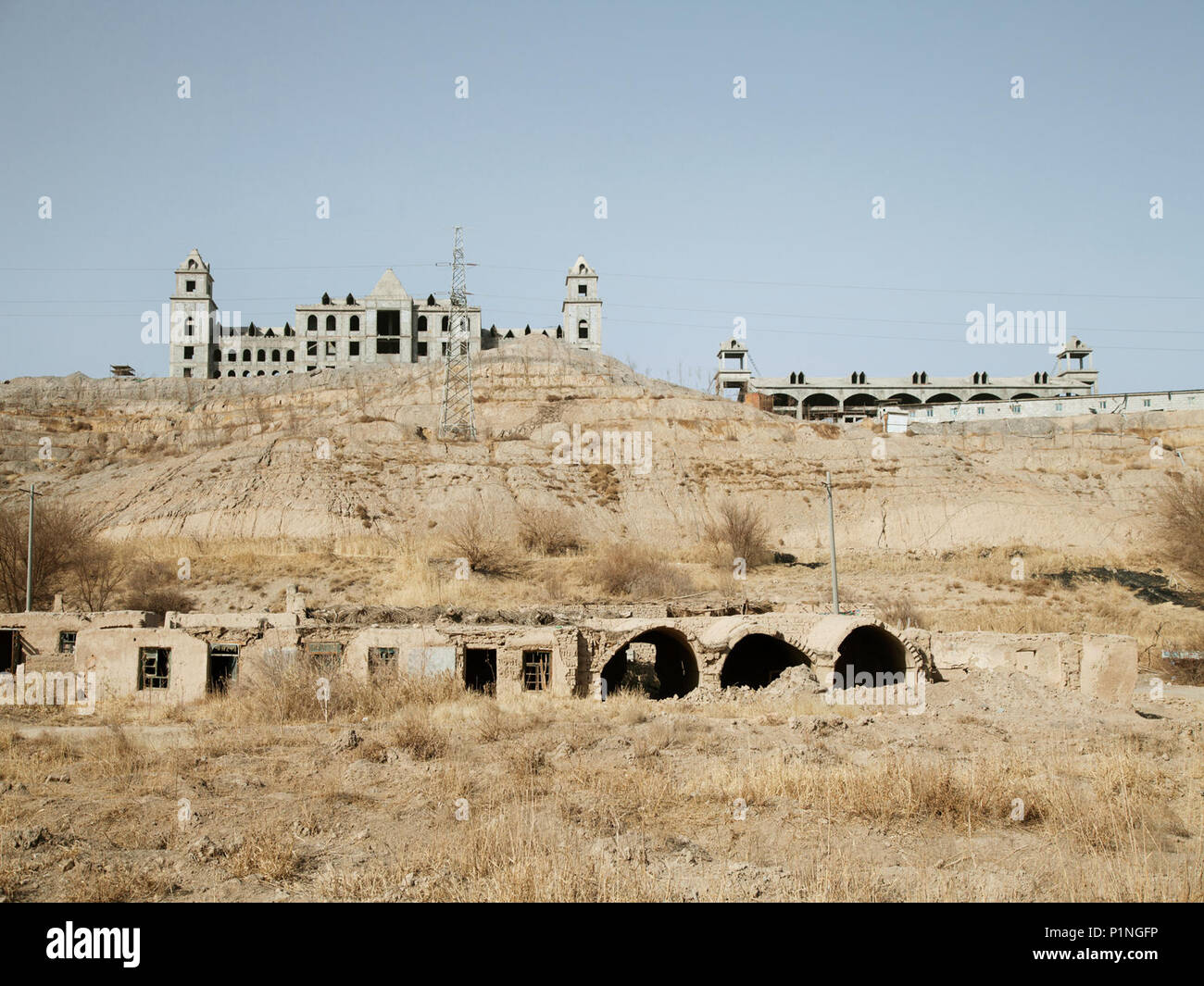 China. 13th June, 2018. The Manor Houses and Abandoned Houses Under Construction at Embankment of Grape Valley in Turpan, Xinjiang, March 2018.Chinese photographer Wang Qing uses the camera to record the development of the Western Wilderness in the current era. Credit: SIPA Asia/ZUMA Wire/Alamy Live News Stock Photo
