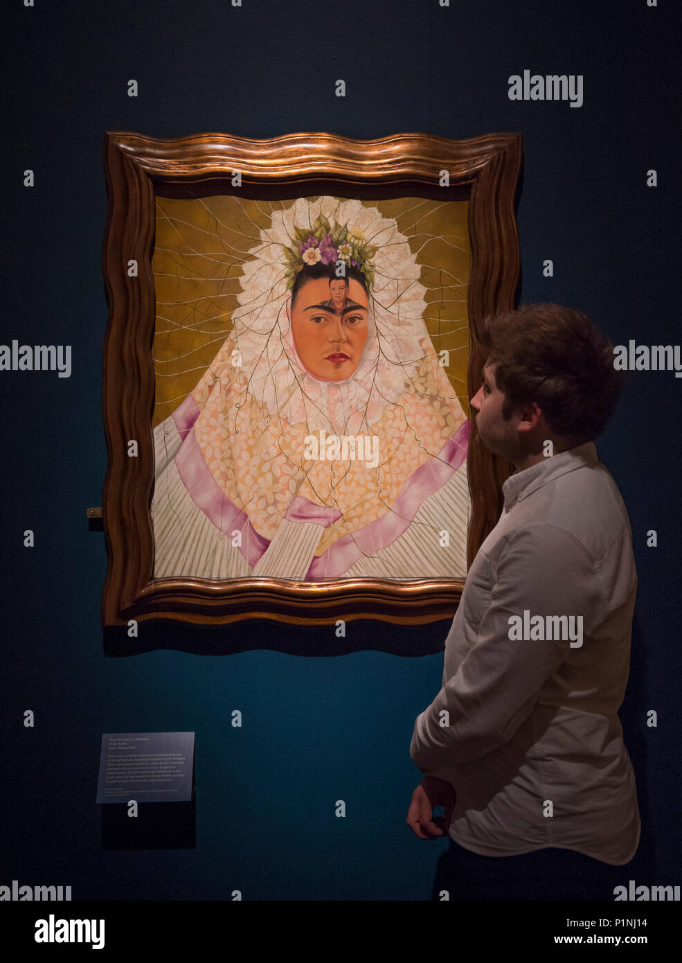 V&A, London, UK. 13 June 2018. Frida Kahlo’s possessions, including 22 outfits, paintings, jewellery and medical paraphernalia, have left Mexico for the first time to go on display at the V&A. The exhibition showcases more than 200 objects from the Blue House, some of which have never been on display before; presenting an unparalleled insight into Kahlo’s life. Photo: Self-portrait as a Tehuana, Frida Kahlo. 1943, Mexico City. The Jacques and Natasha Gelman Collection of 20th Century Mexican Art and The Vergel Collection. Posed with Museum staff. Credit: Malcolm Park editorial/Alamy Live News Stock Photo