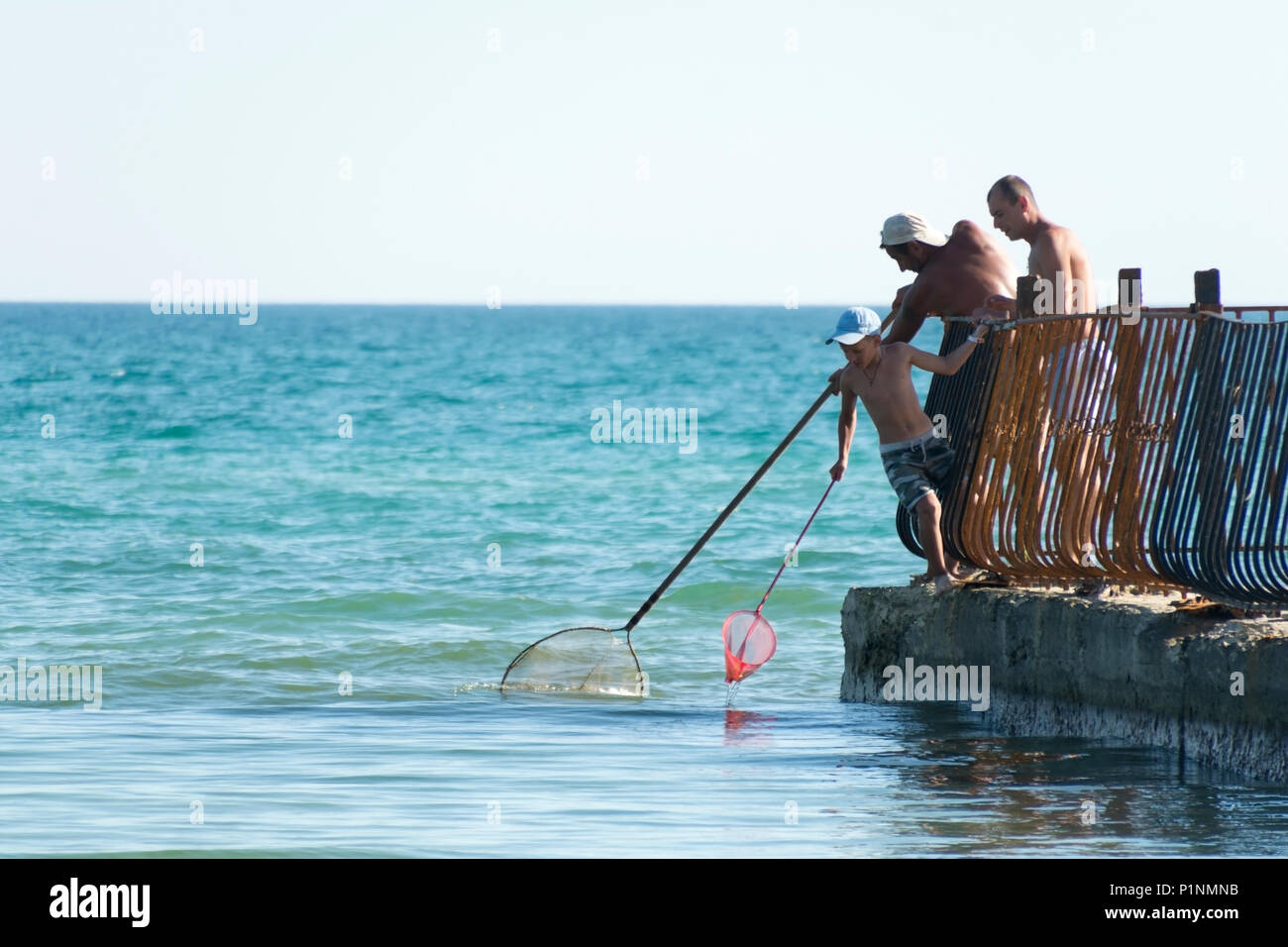 Old man fishing from pier hi-res stock photography and images - Alamy