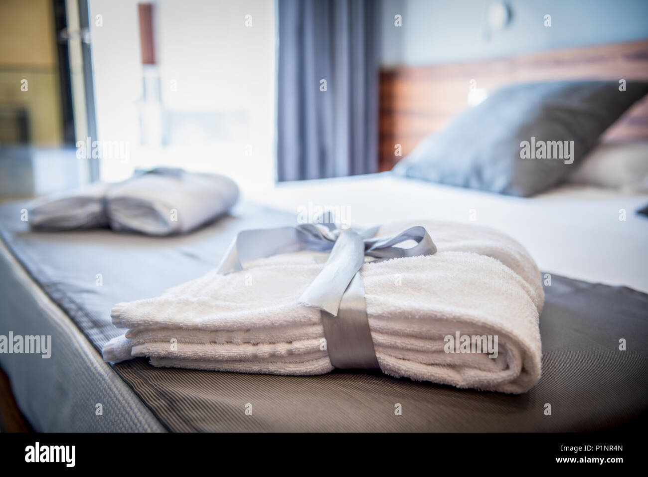 Bathrobe on bed in hotel room Stock Photo Alamy