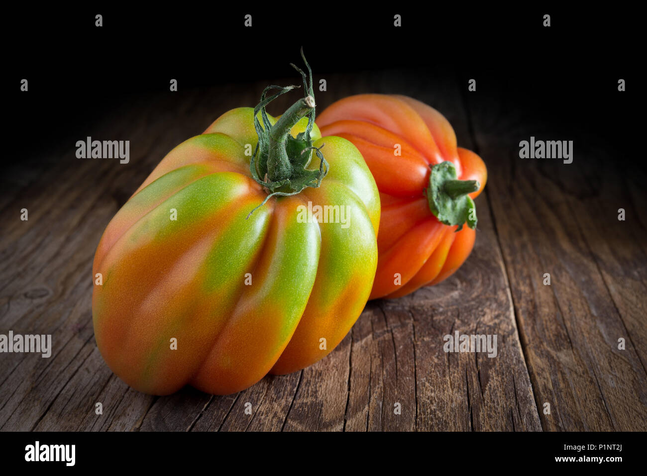 Top view of raw tomato called ox hearth  on wooden background Stock Photo