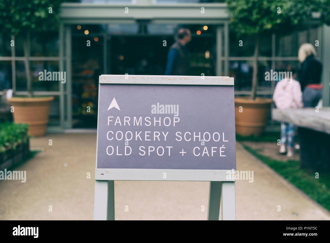 Farmshop, Cookery school, old spot and cafe sign at Daylesford Organic farm shop summer festival. Daylesford, Cotswolds, Gloucestershire, England. Stock Photo