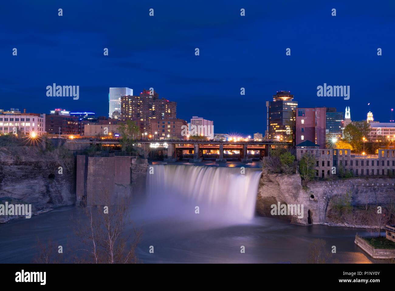 ROCHESTER, NY - MAY 14, 2018: Skyline of Rochester, New York at the High Falls along the Genesee River at night Stock Photo