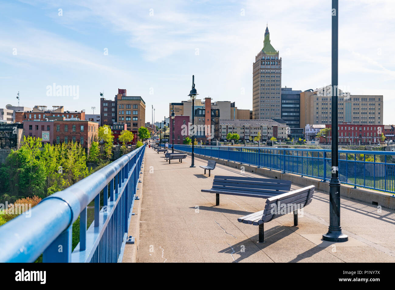 ROCHESTER, NY - MAY 14, 2018: Skyline of Rochester, New York along the Pont De Rennes Pedestrian Bridge which is part of the Genesee Riverway Trail Stock Photo
