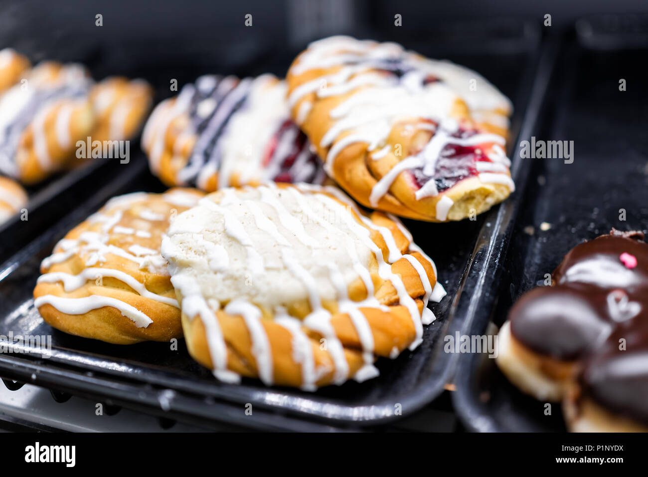 Closeup Of Many Yellow Cream Cheese Berry Fruit Icing Drizzled Baked Danish Pastries On Shelf Tray Display Desserts In Bakery Shop Cafe Store Stock Photo Alamy