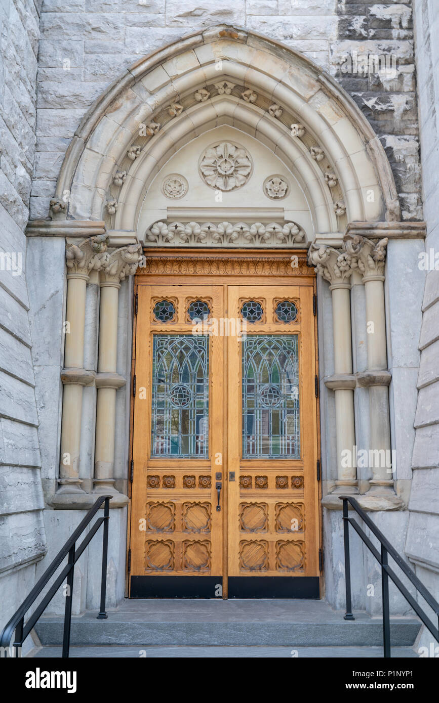 Stone Gothic Arch Church Entrance with Stained Glass Door Stock Photo