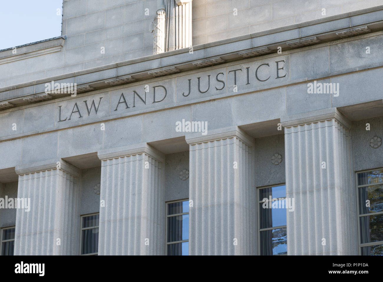 Stone Facade of Courthouse with Law and Justice Stock Photo