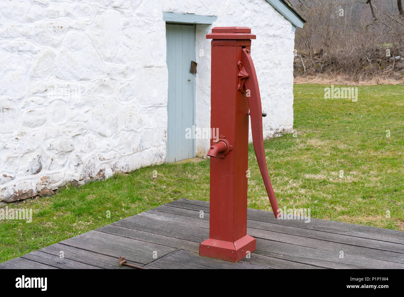 Old Red Manual Water Well Pump Stock Photo
