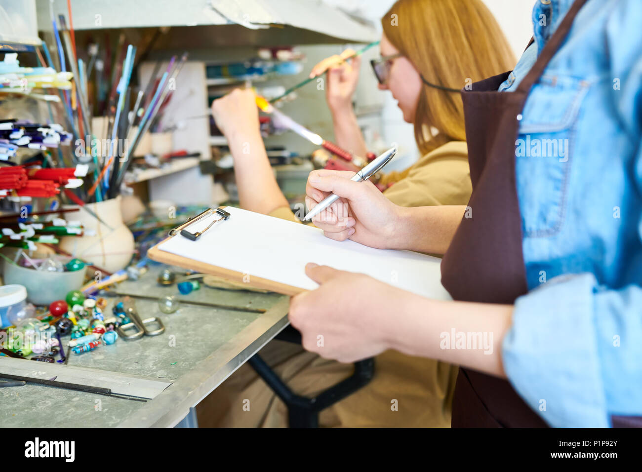 Female Artists Collaborating in Workshop Stock Photo