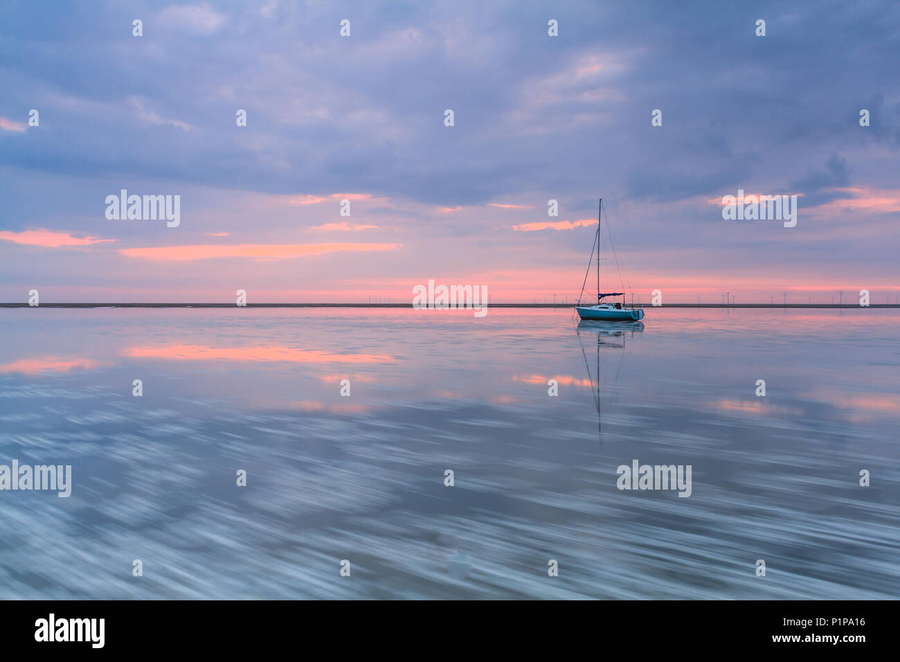 Sunset at Meols, Wirral, UK, with high tide and yachts Stock Photo