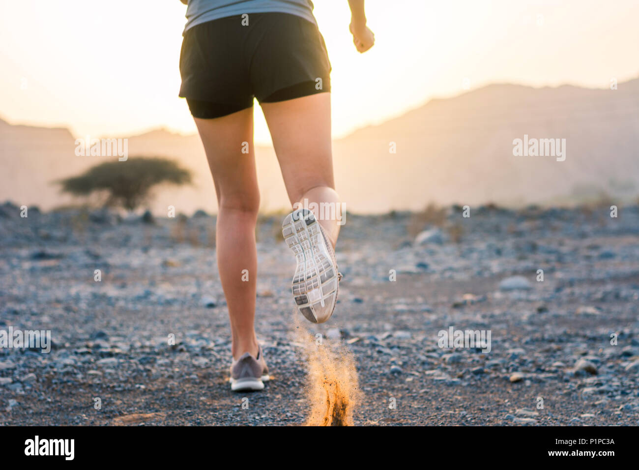 Female running in the desert low angle view Stock Photo