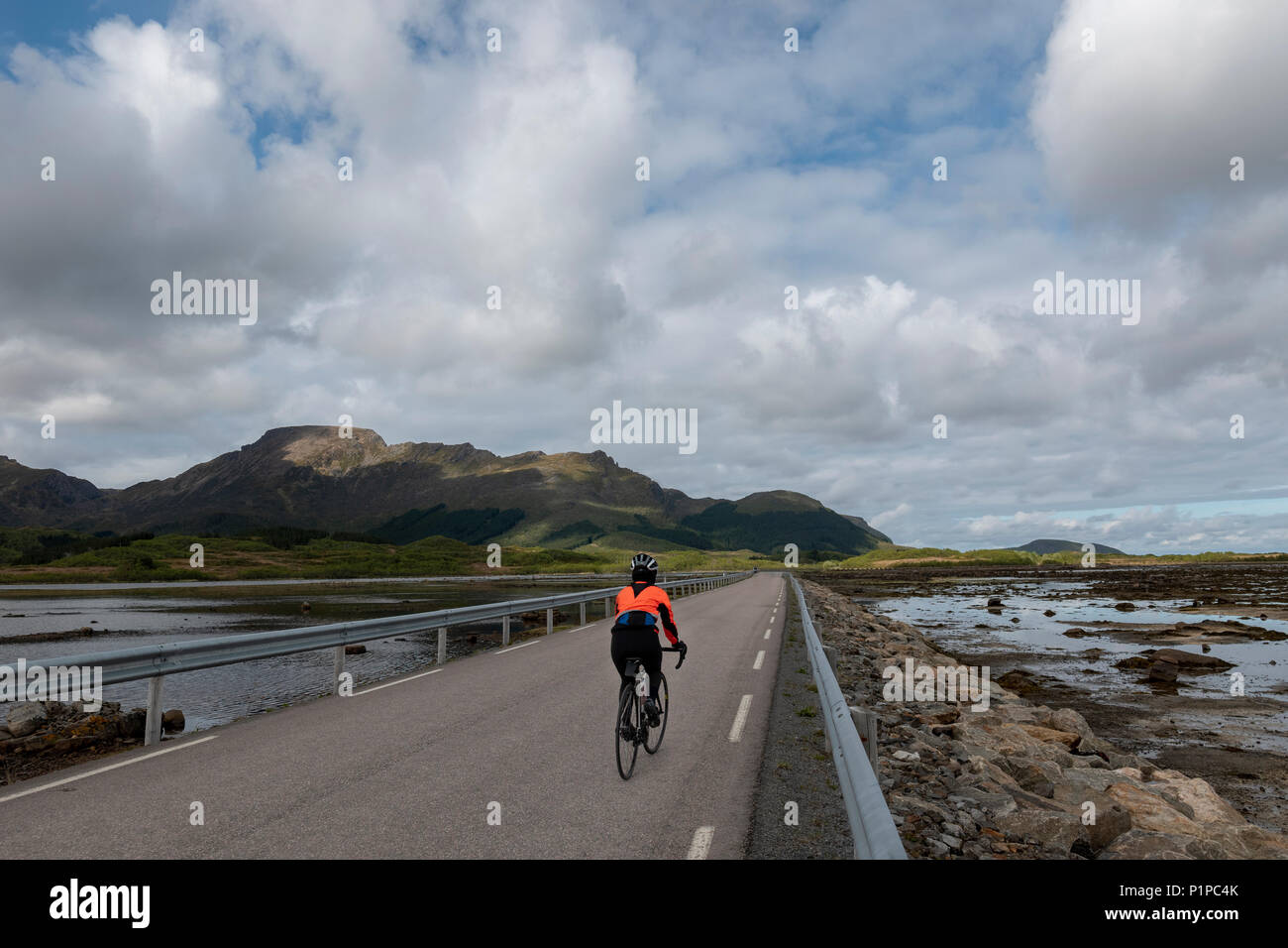Female cyclist in the Lofoten Islands, Norway Stock Photo