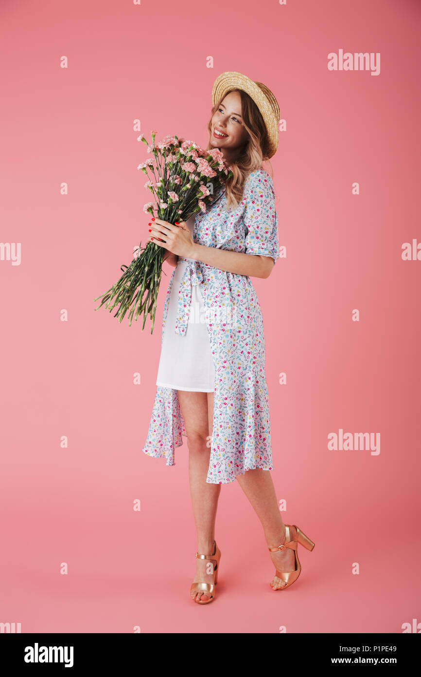 Full length portrait of a beautiful young woman in summer dress and ...