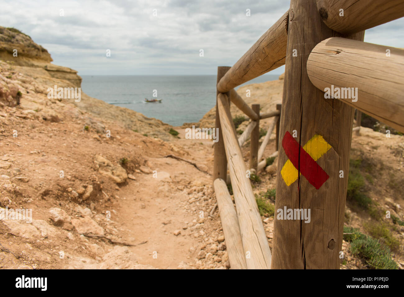 Fingerpost in the Algarve, Portugal. These fingerposts are used to mark walking routes and have recognisable red and yellow markings. Stock Photo