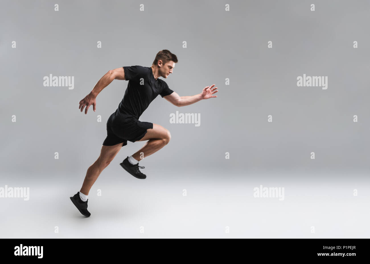 Running Portrait Full length portrait of a focused young sportsman running fast isolated ...