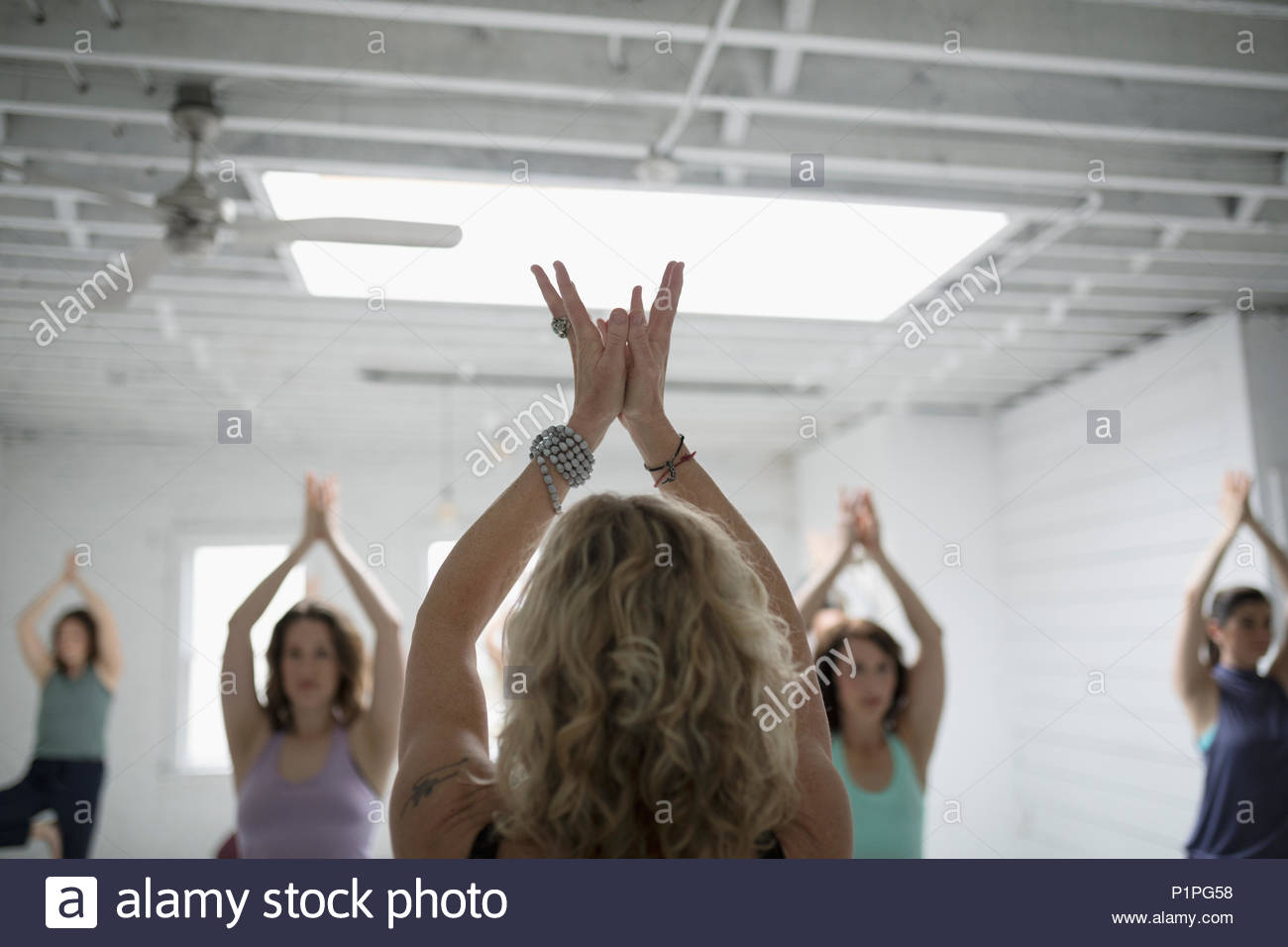 Women practicing padma mudra in yoga class Stock Photo