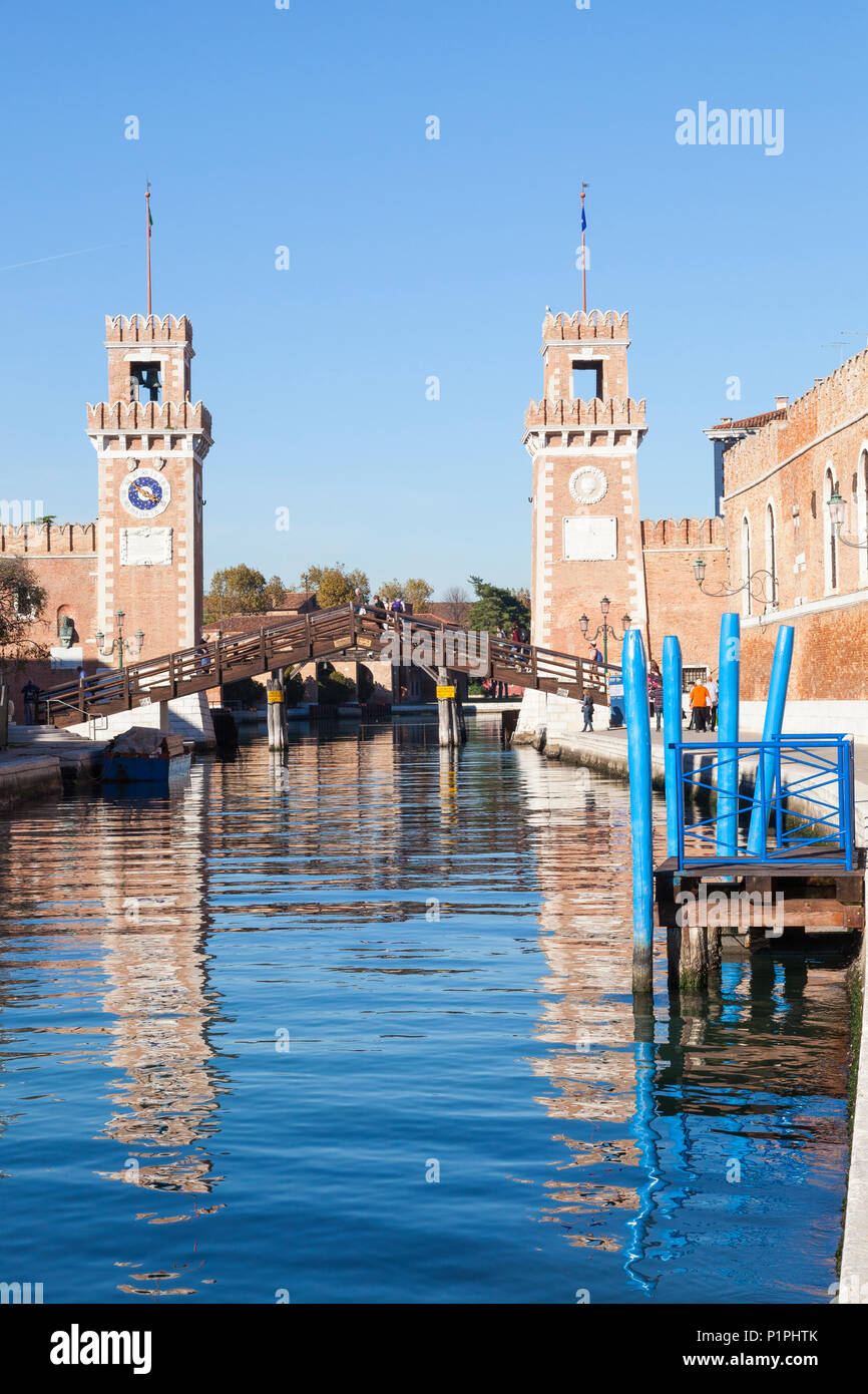 The Ponte de l'Arsenal o del Paradiso, Arsenale, Castello, Venice, Veneto, Italy over the Rio de l'Arsenale at sunset with reflections in the canal Stock Photo