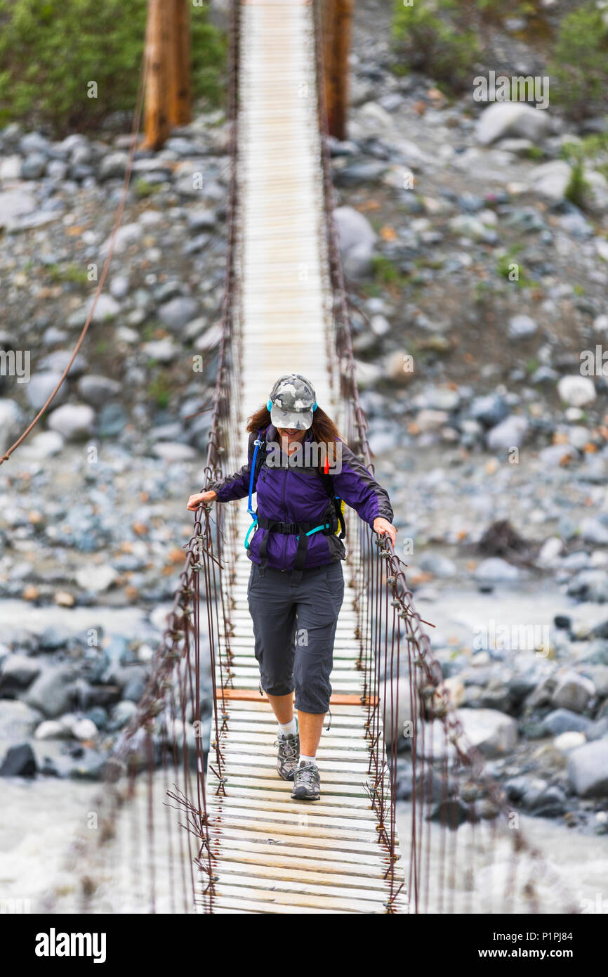 Image of people crossing a scary bridge hires stock photography and