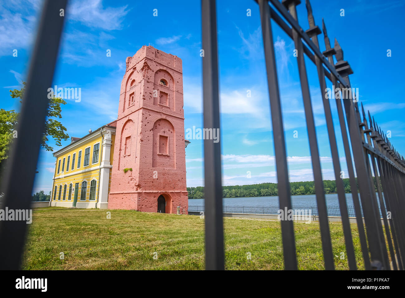 VUKOVAR, CROATIA - MAY 14, 2018 : Renovated tower that is part of the City museum on the coast of river Danube viewed thru the fence in Vukovar, Croat Stock Photo