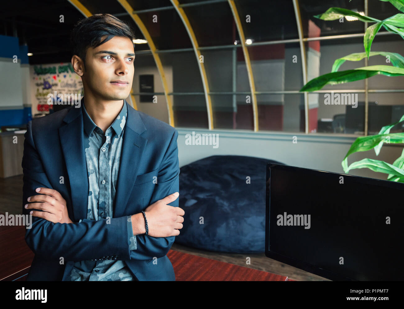Portrait of a young millennial businessman in the workplace; Sherwood Park, Alberta, Canada Stock Photo