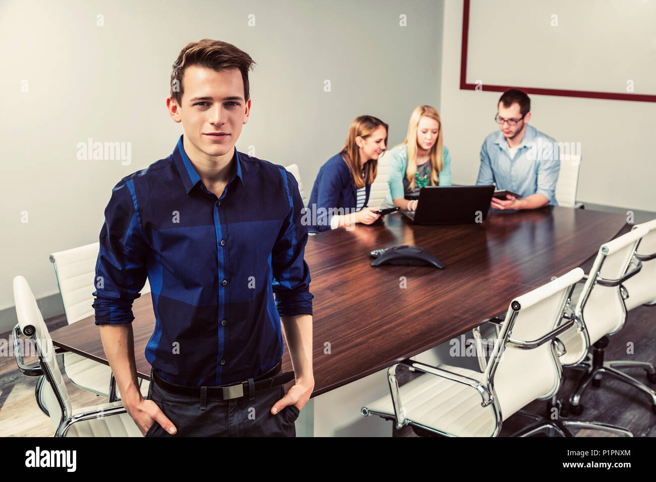Young millennial business professionals working together in a conference room in a high tech modern business; Sherwood Park, Alberta, Canada Stock Photo