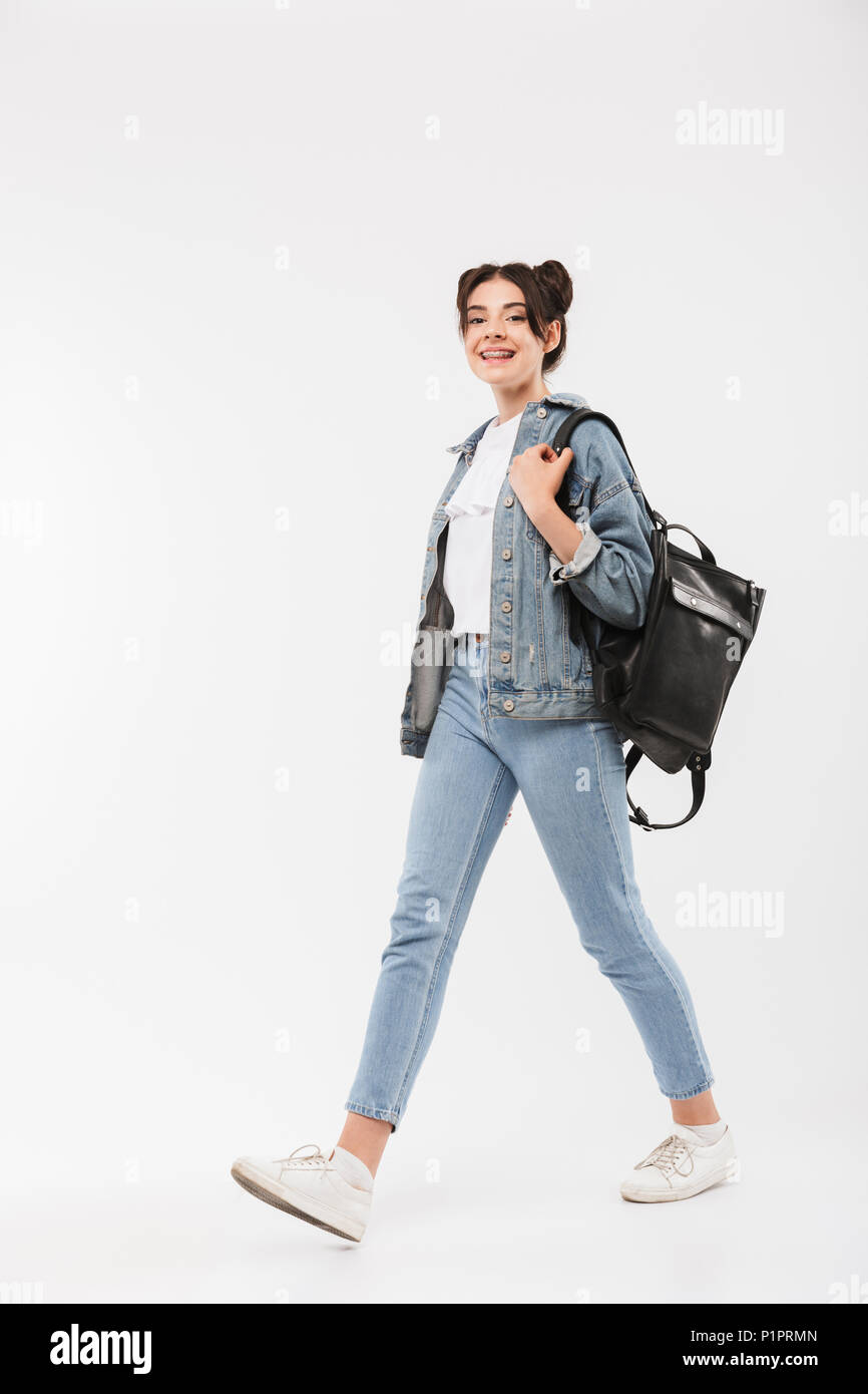 Full length photo of happy student girl 20s with double buns hairstyle wearing jeans clothing and backpack walking with smile isolated over white back Stock Photo - Alamy Full length photo of happy student girl 20s with double buns hairstyle wearing jeans clothing and backpack walking with smile isolated over white back Stock Photo - Alamy