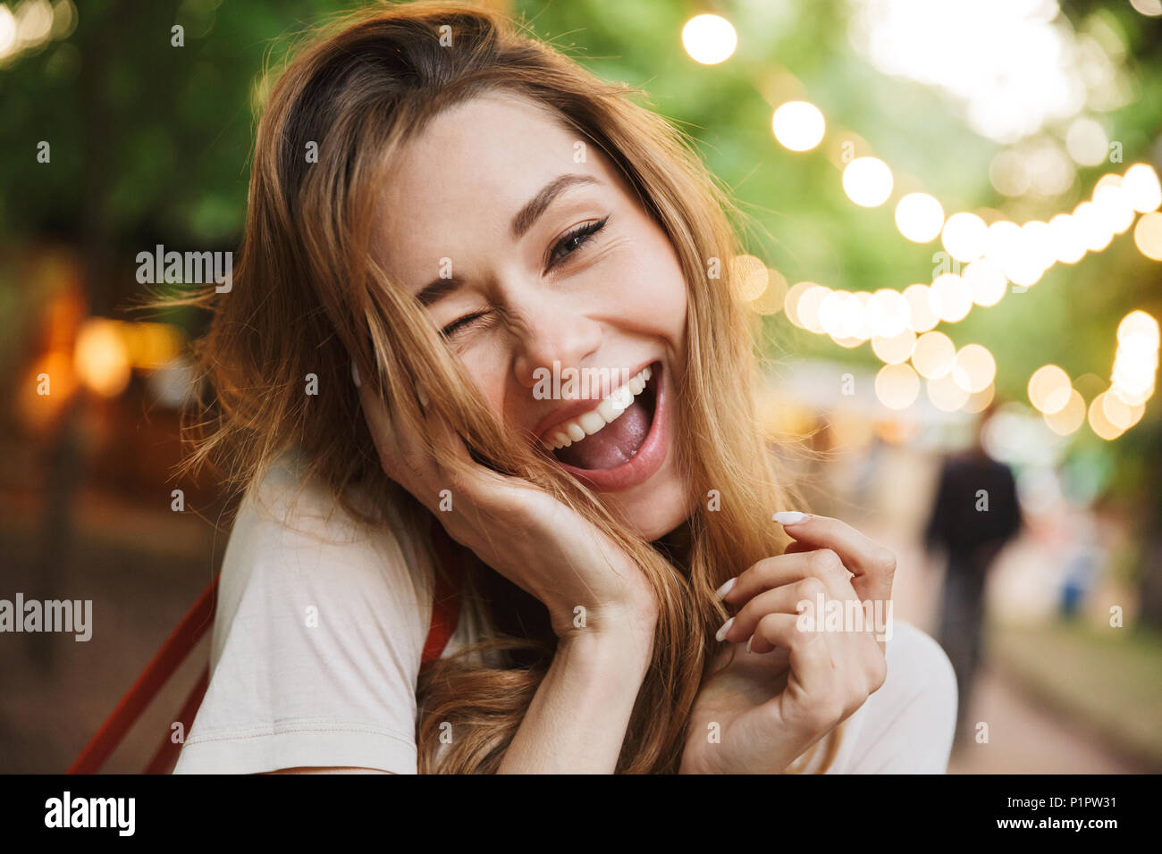 Close up of cheerful young girl screaming while standing at the park Stock Photo