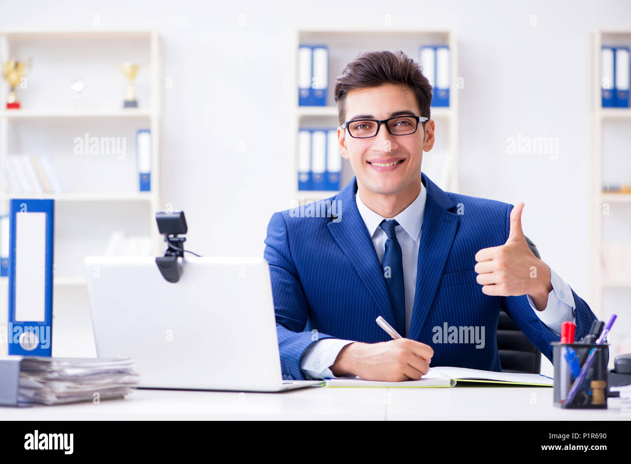 Young help desk operator working in office Stock Photo - Alamy