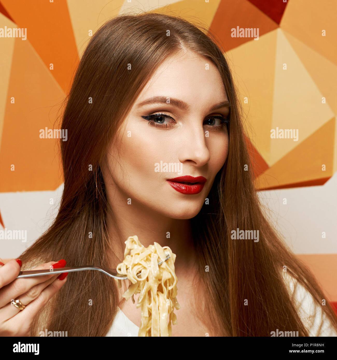Portrait of attractive long haired woman with slightly ajar mouth and red lips eating Italian