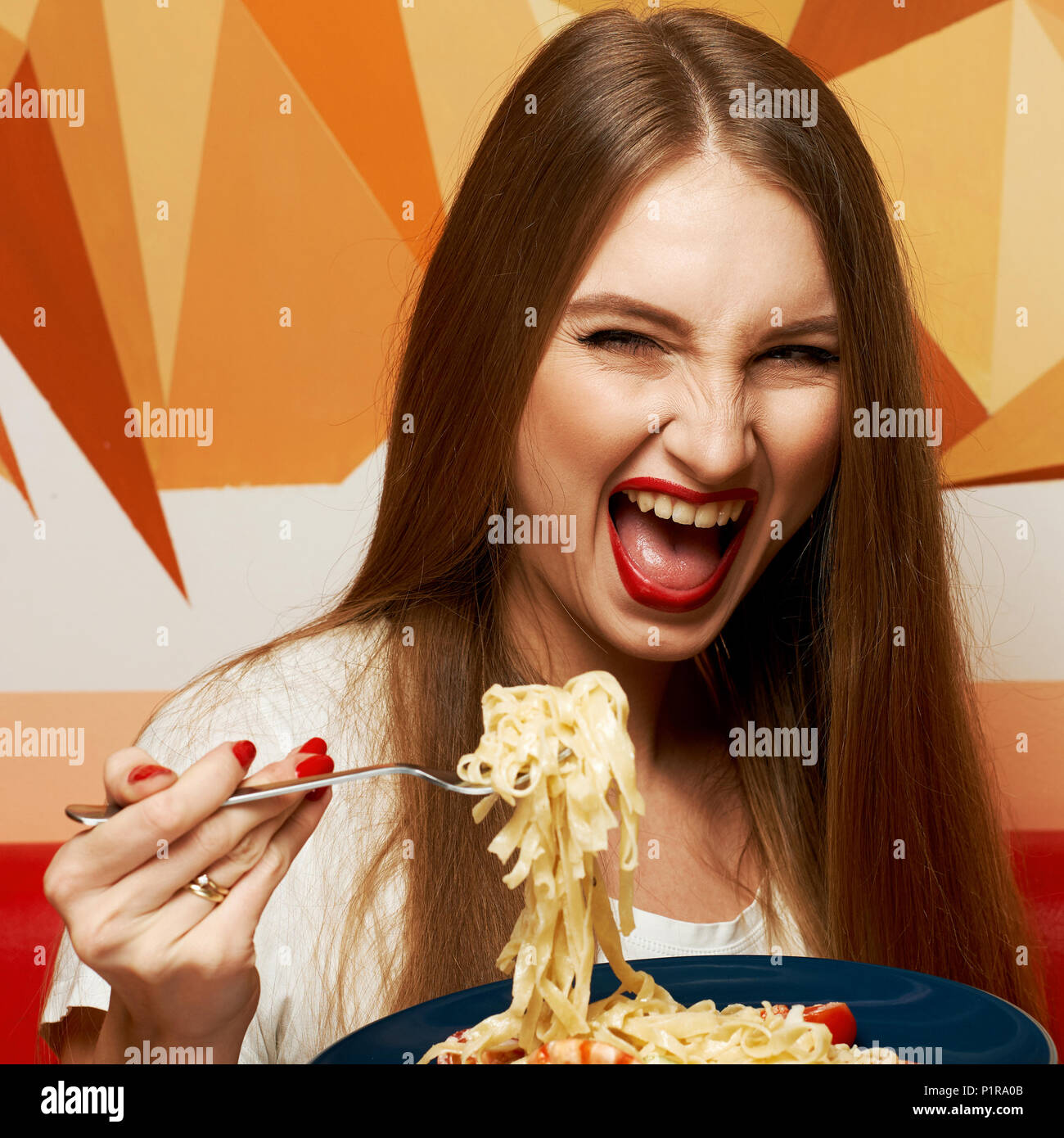 Laughing beautiful long haired woman with expressively opened mouth