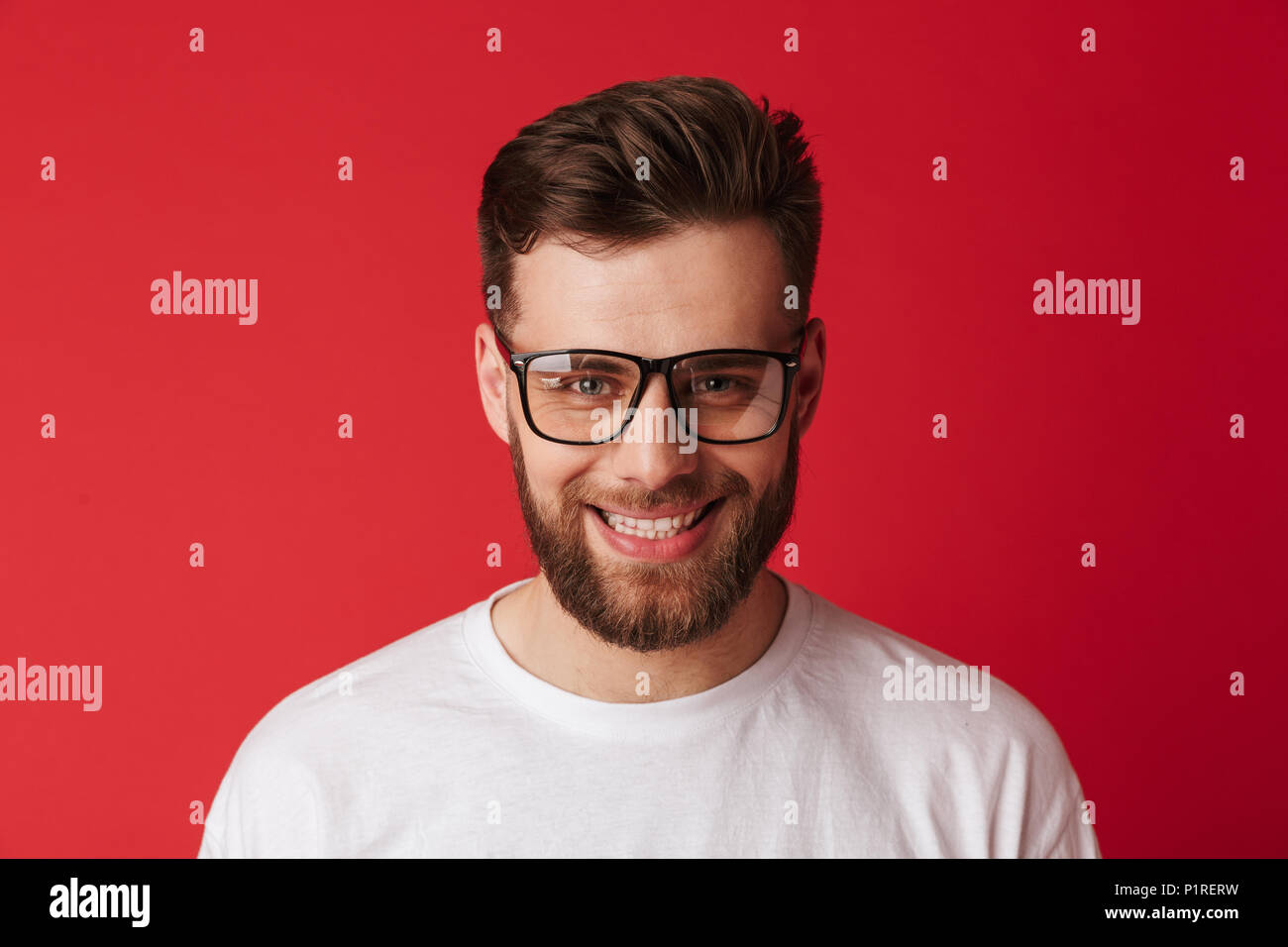 Image of handsome young smiling man wearing glasses standing isolated ...