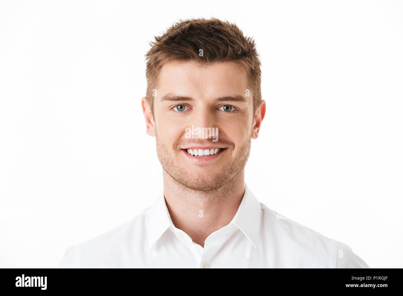 Close up portrait of a smiling young man looking at camera isolated ...