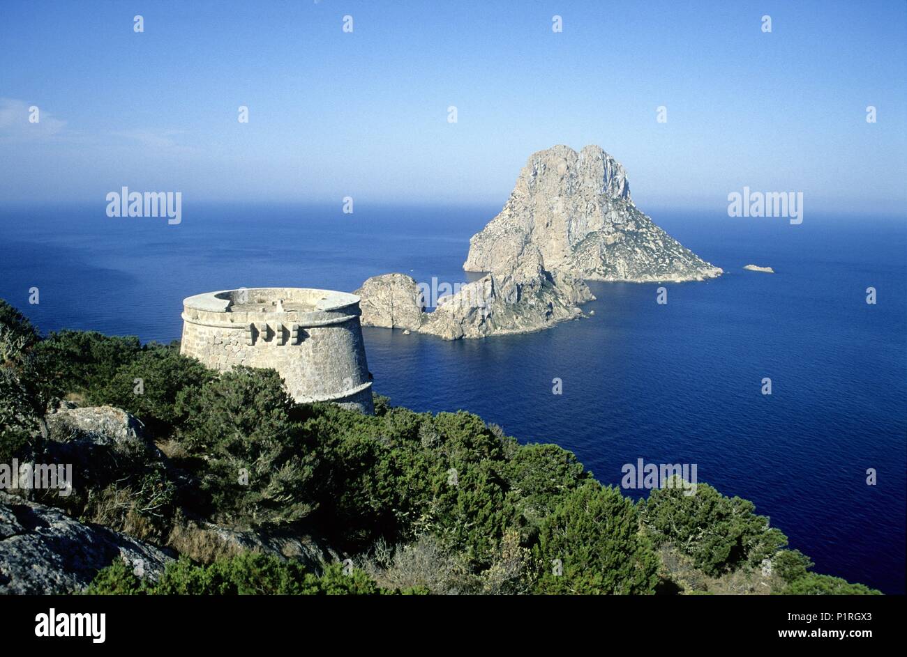 Es Vedrá isle seen from the  'des Savinar' viewpoint; Torre del Pirata (Pirate Tower). Stock Photo