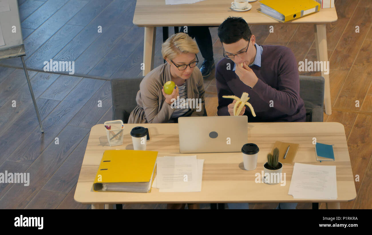 Workers enjoying lunch break in the office Stock Photo