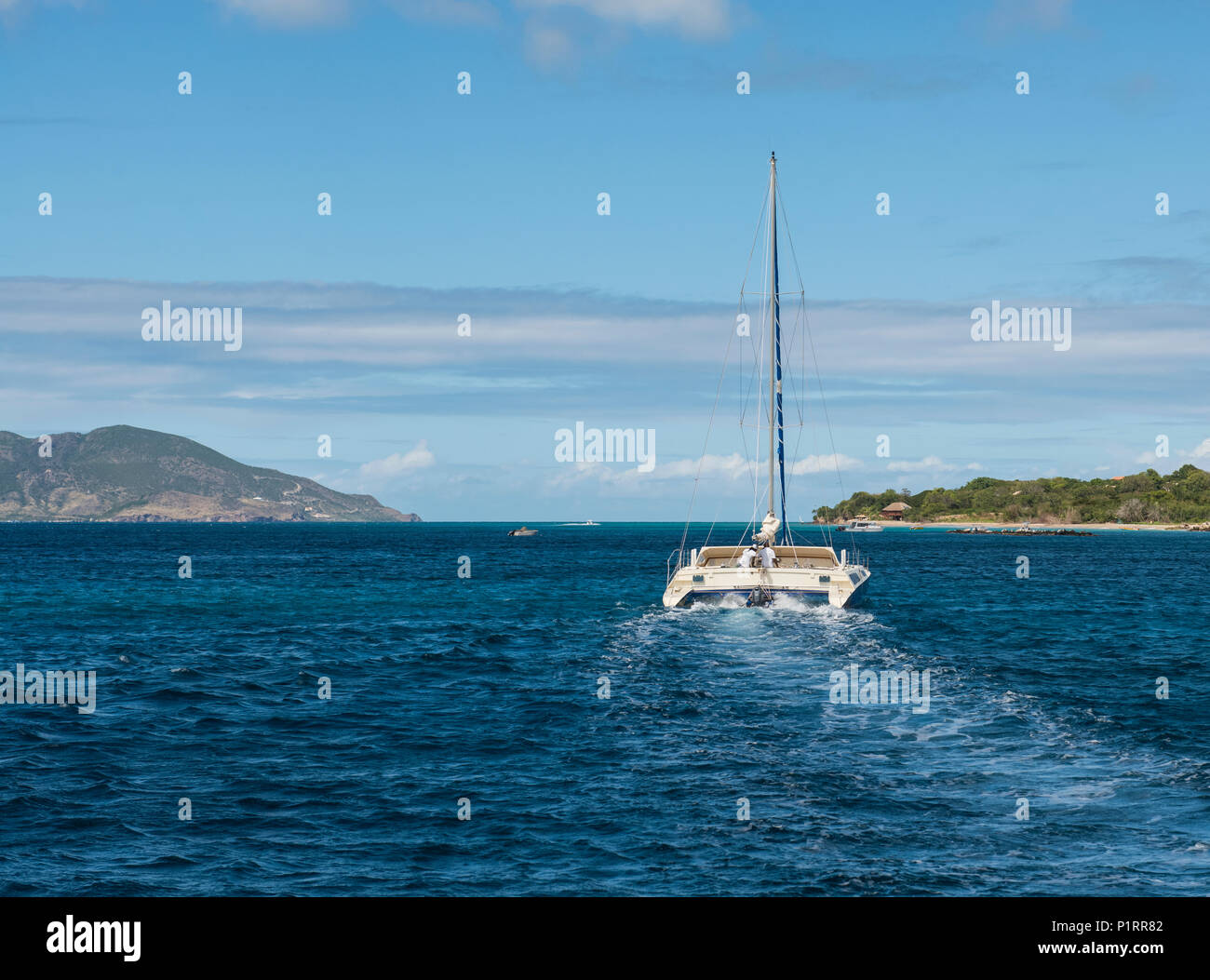 Two men sailing a catamaran sailing near island of Nevis in the