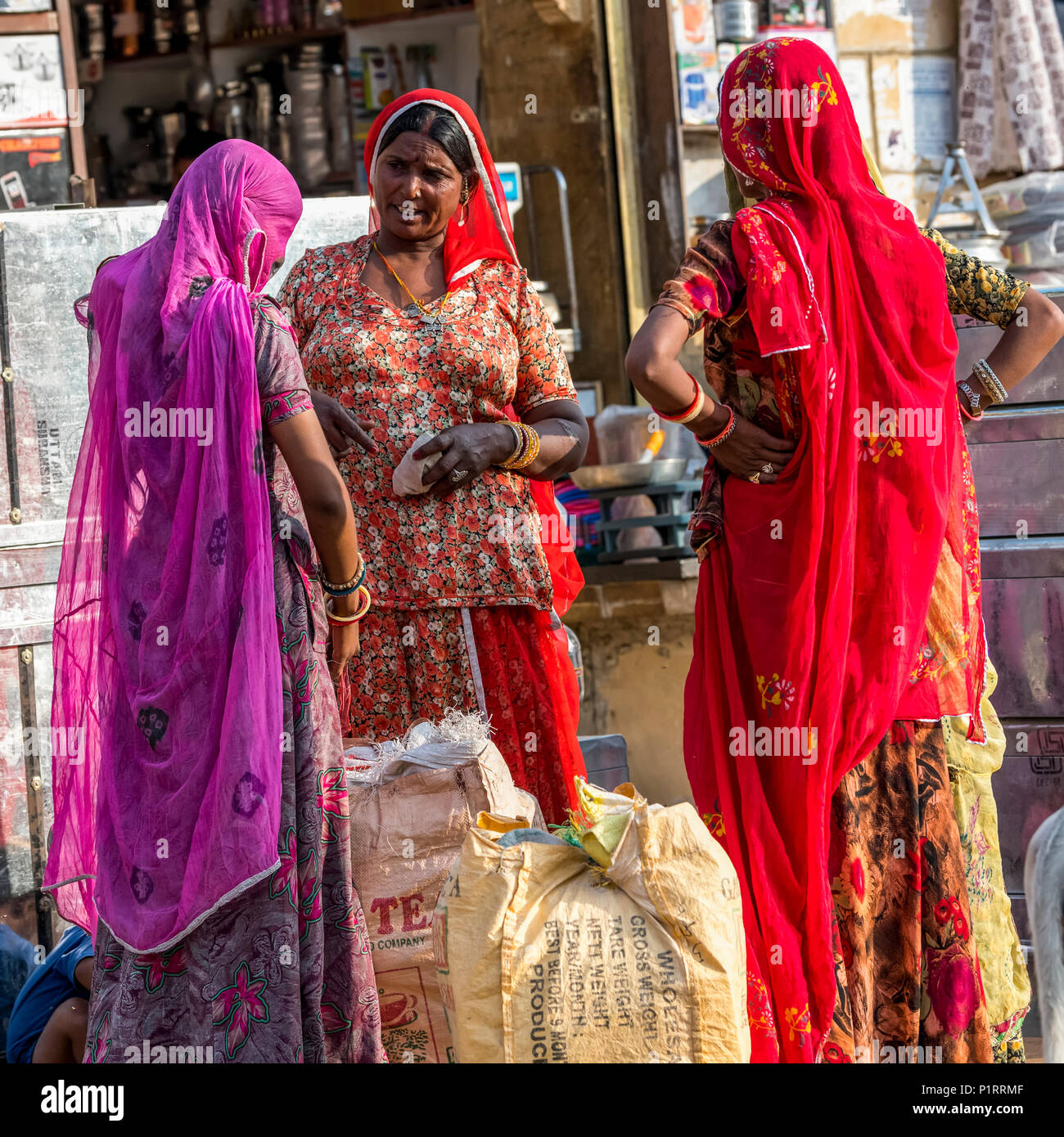 Three Indian women talking outside a shop; Jaisalmer, Rajasthan, India Stock Photo