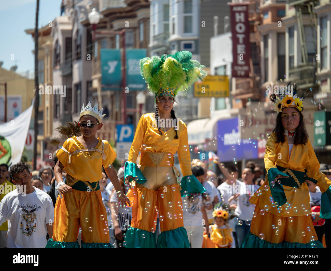 SAN FRANCISCO, CA – MAY 27, 2018: Woman on stilts and Mexican festive wear walks down the street at the Carnaval festival Stock Photo