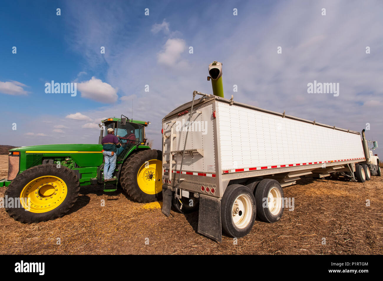 Two farmers discuss harvest during corn harvest, near Nerstrand